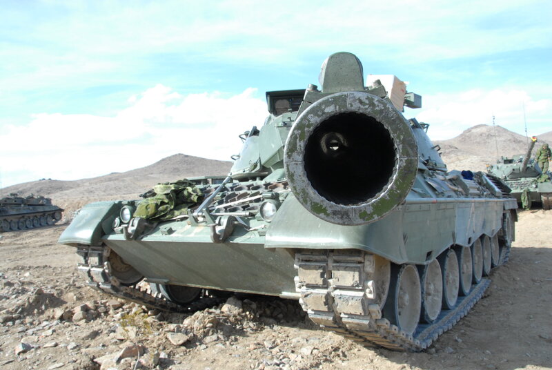 Military tank in desert terrain