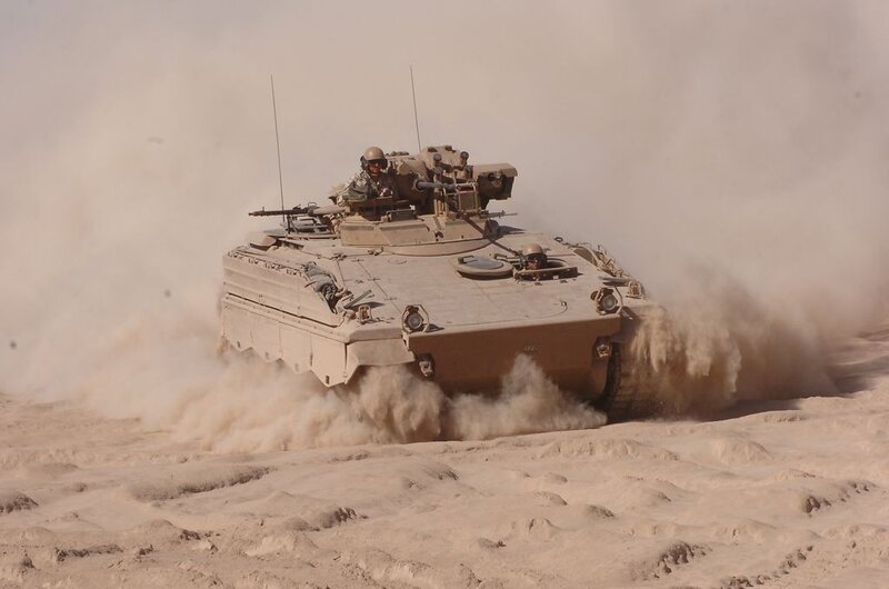 Military tank in desert terrain