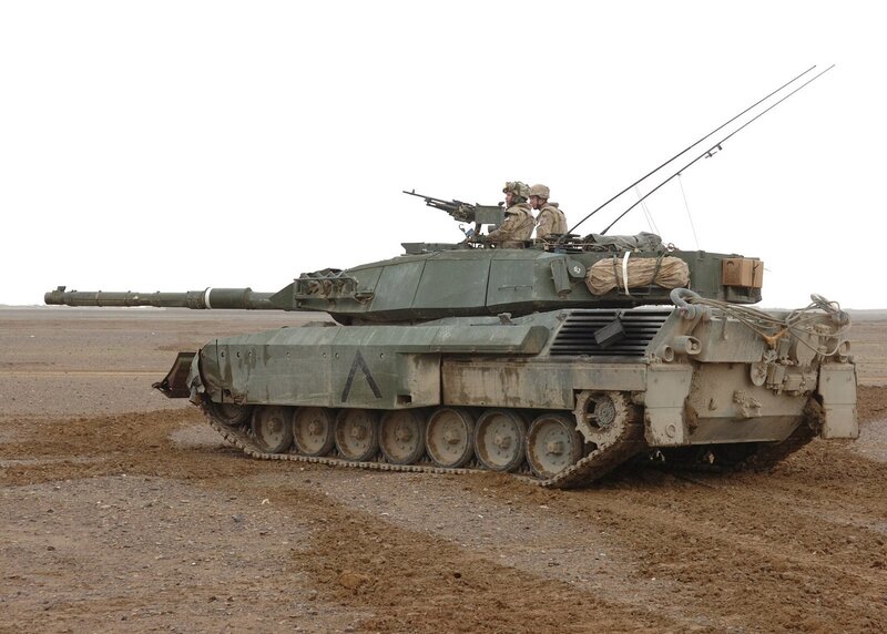 Military tank in desert terrain