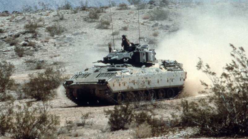 Military tank in desert terrain