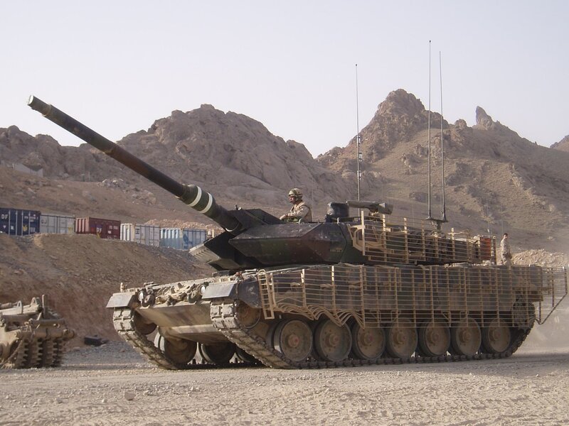 Military tank in desert terrain