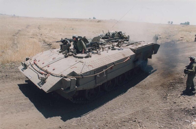 Military tank in desert terrain