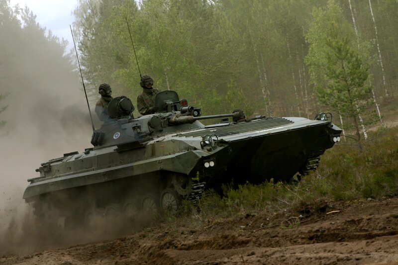 Military tank in forest terrain