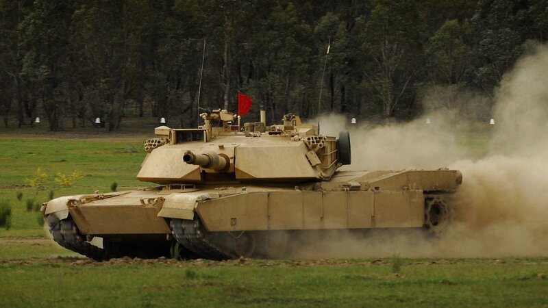 Military Tank in Motion — Tan
