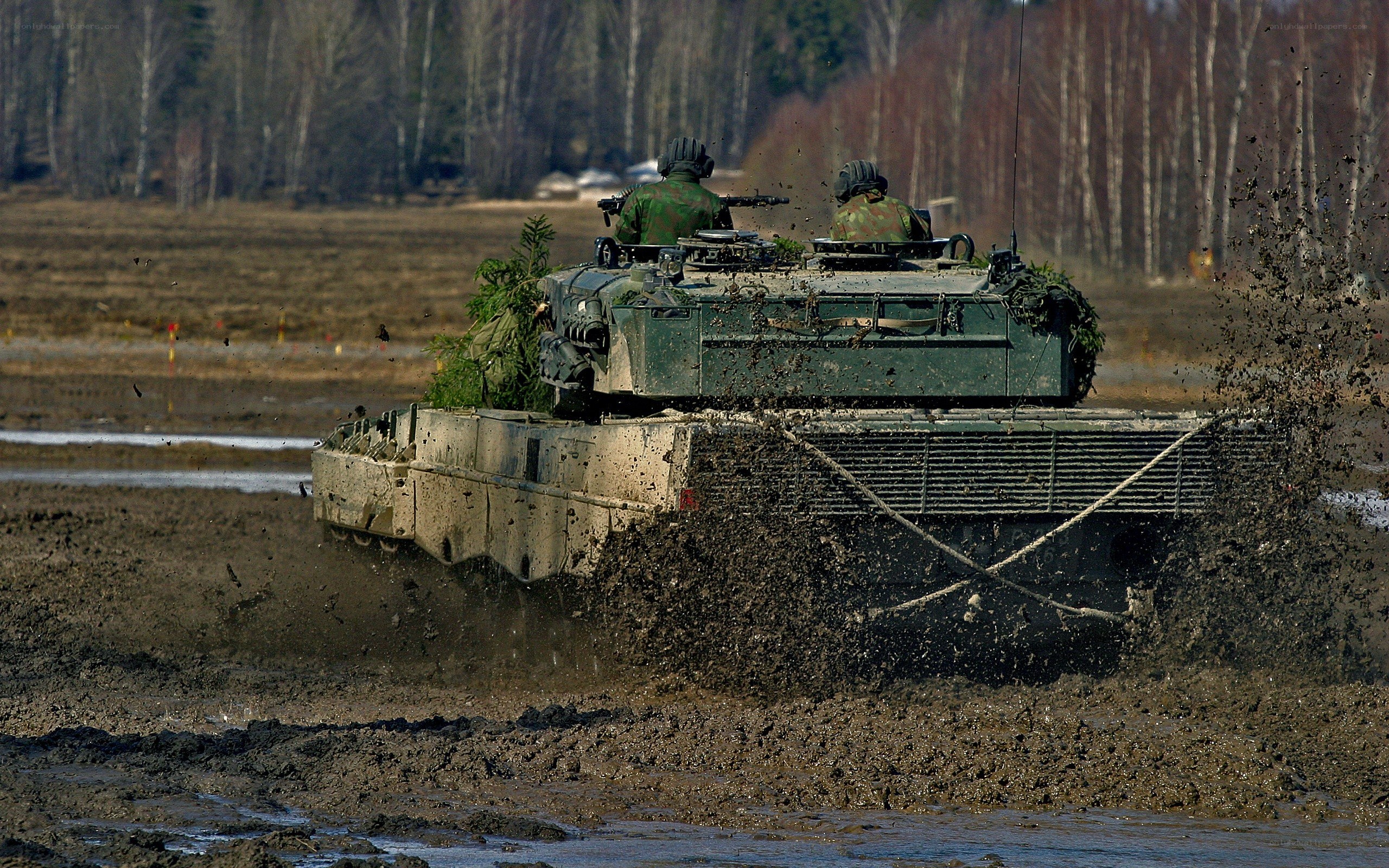 Military tank in muddy field