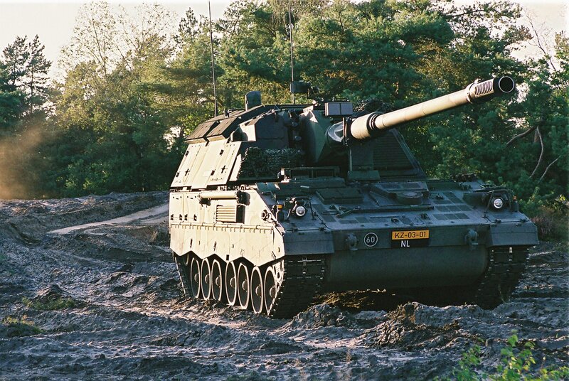 Military tank in muddy terrain
