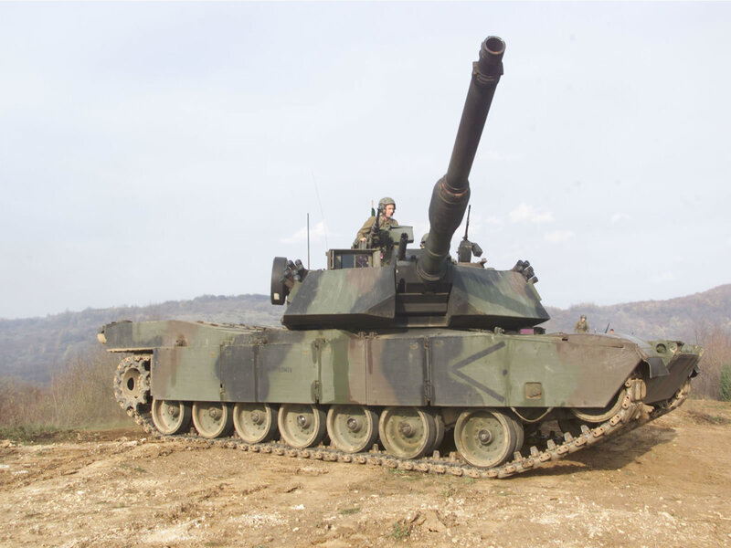 Military tank on a dirt field