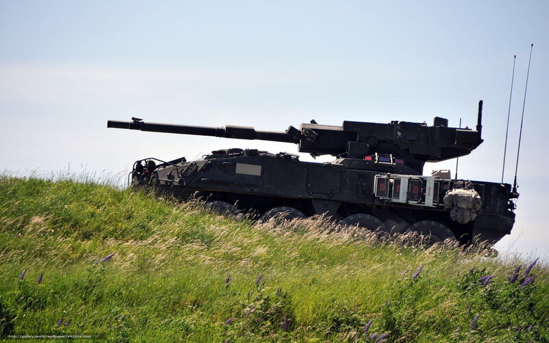 Military tank on a grassy hill