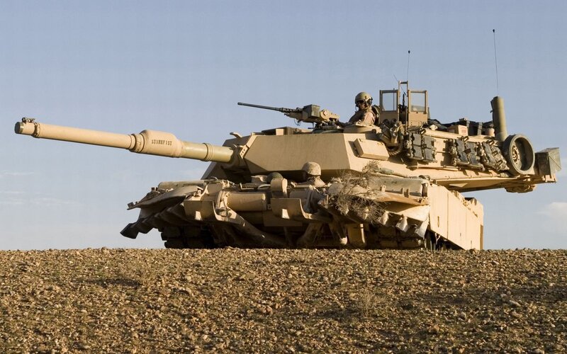 Military tank on desert terrain