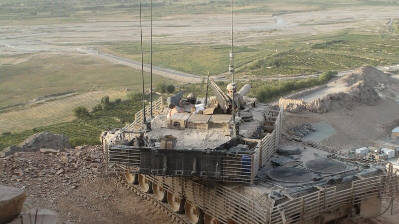 Military tank on hilltop