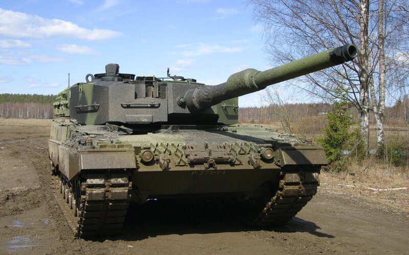 Military tank on muddy field