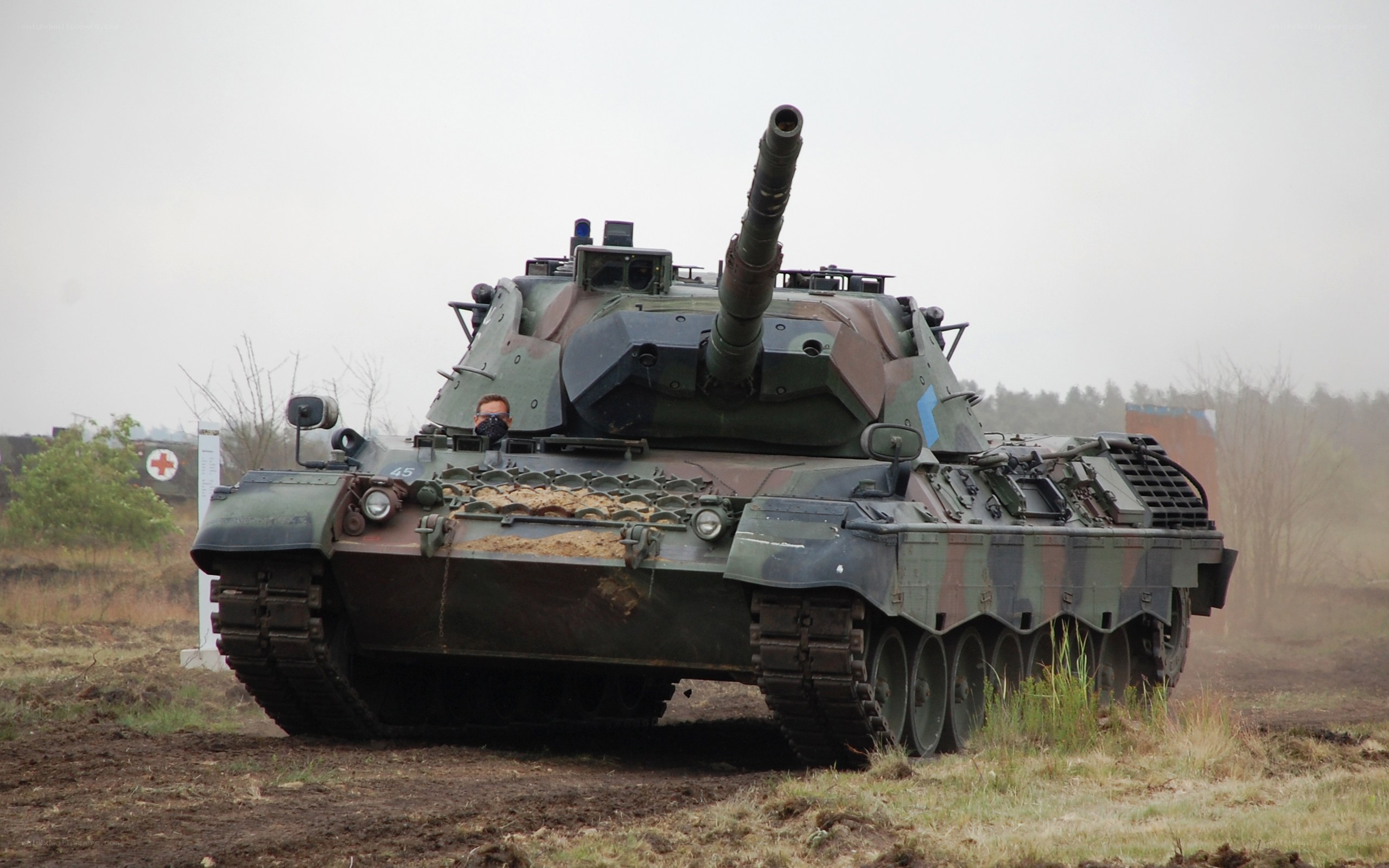 Military tank on muddy field
