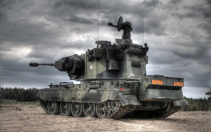 Military tank on sandy field