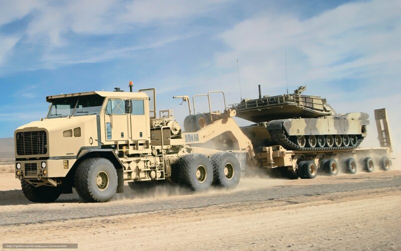 Military tank transport in desert