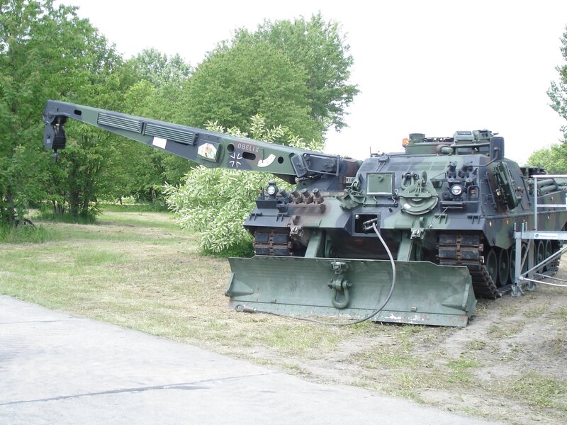 Military tank with crane attachment