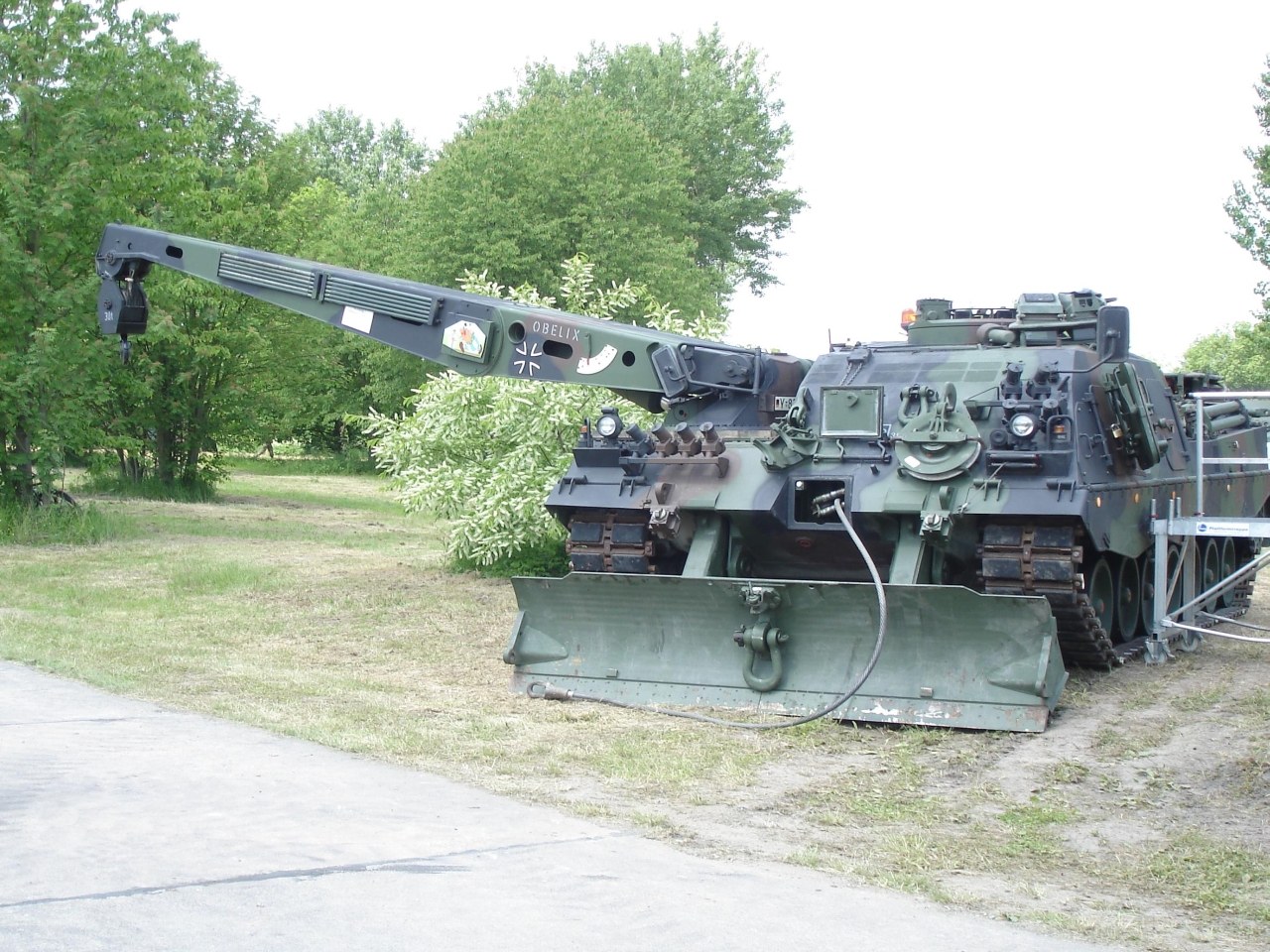 Military tank with crane attachment