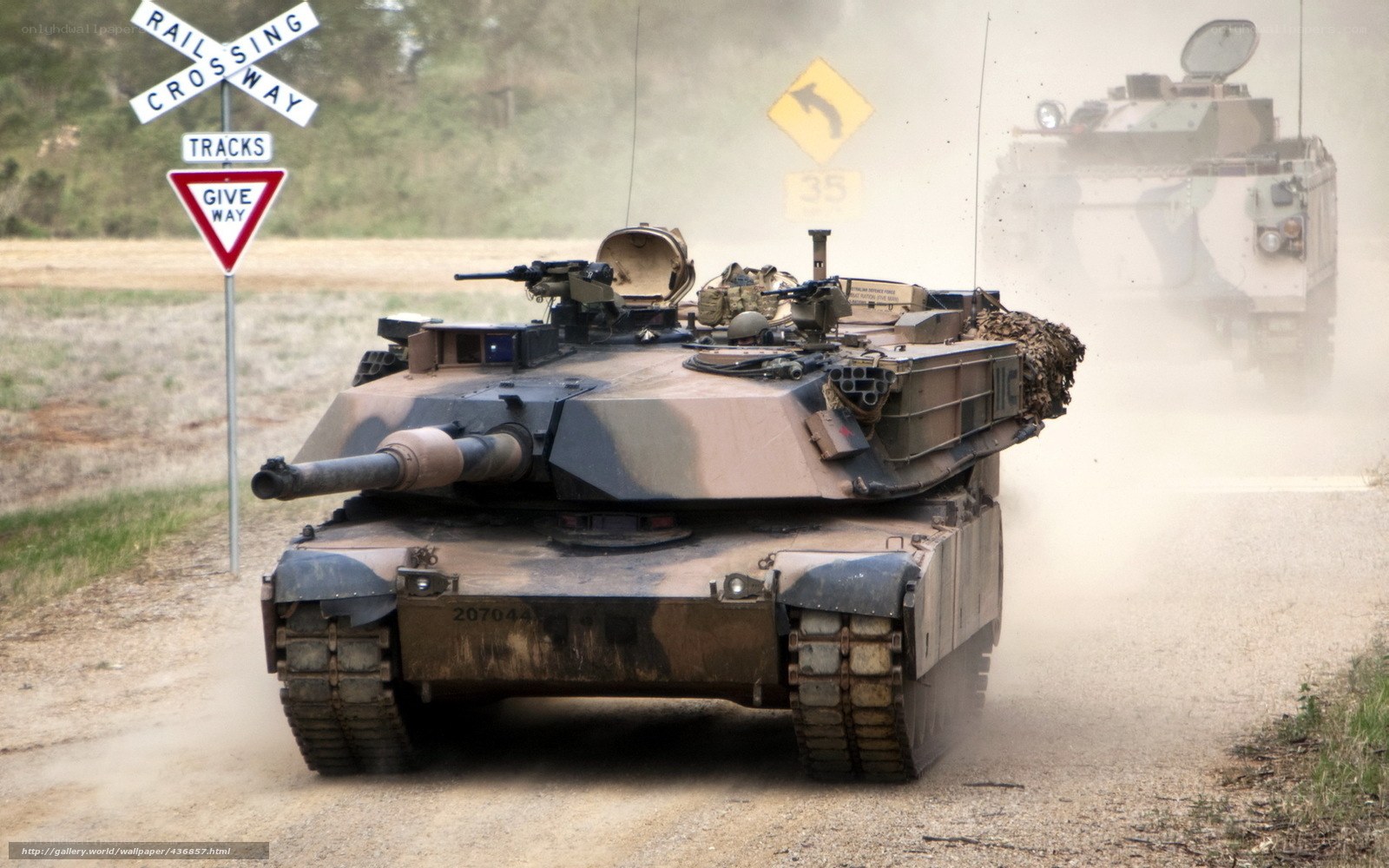 Military tanks at rail crossing