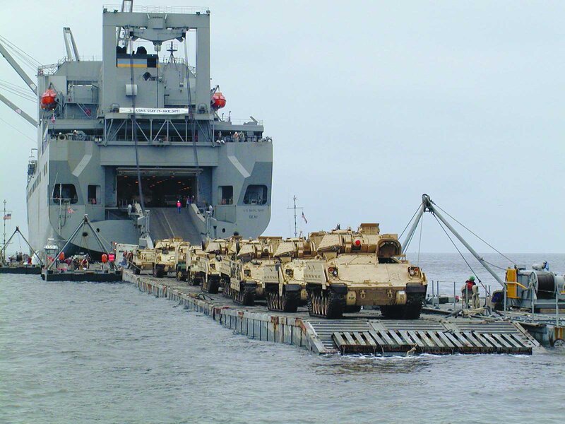 Military tanks being unloaded from ship
