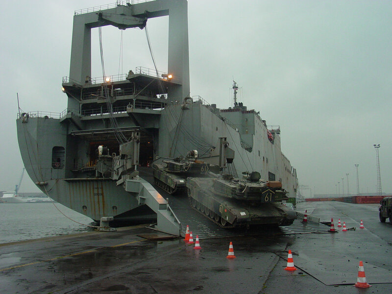 Military tanks being unloaded from ship