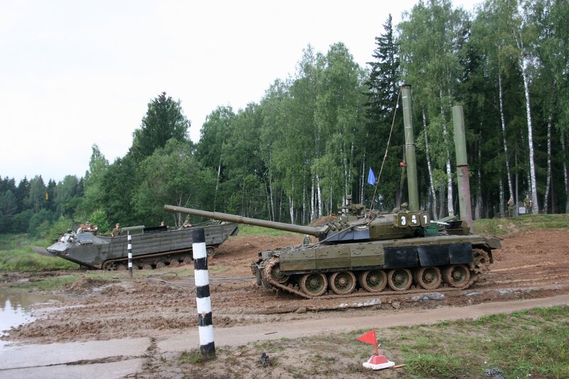 Military tanks in a muddy field