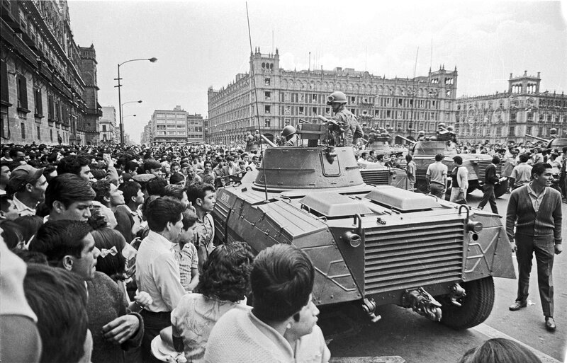 Military tanks in city crowd