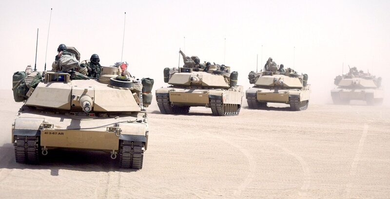 Military tanks in desert formation