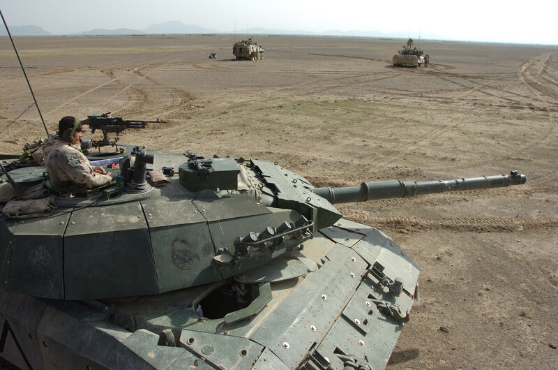 Military tanks in desert terrain