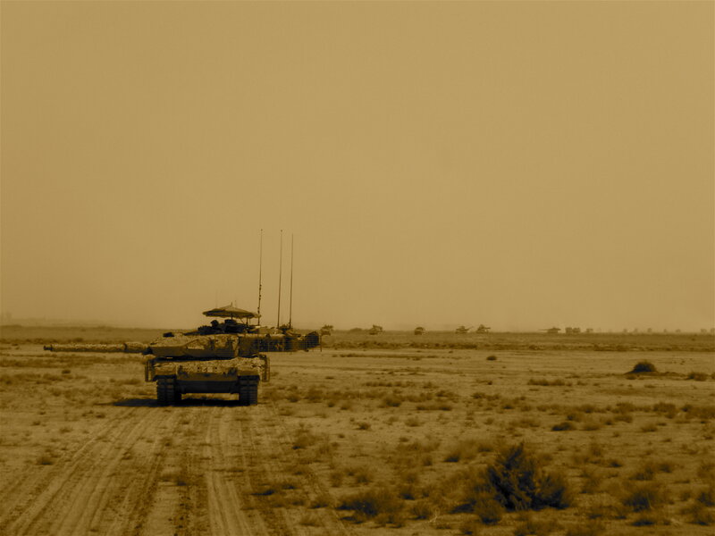Military tanks in desert terrain