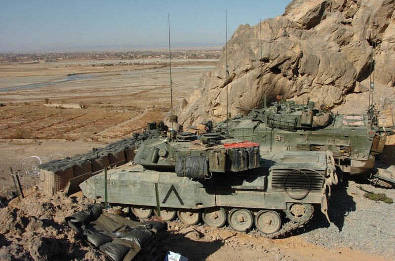 Military tanks in desert terrain