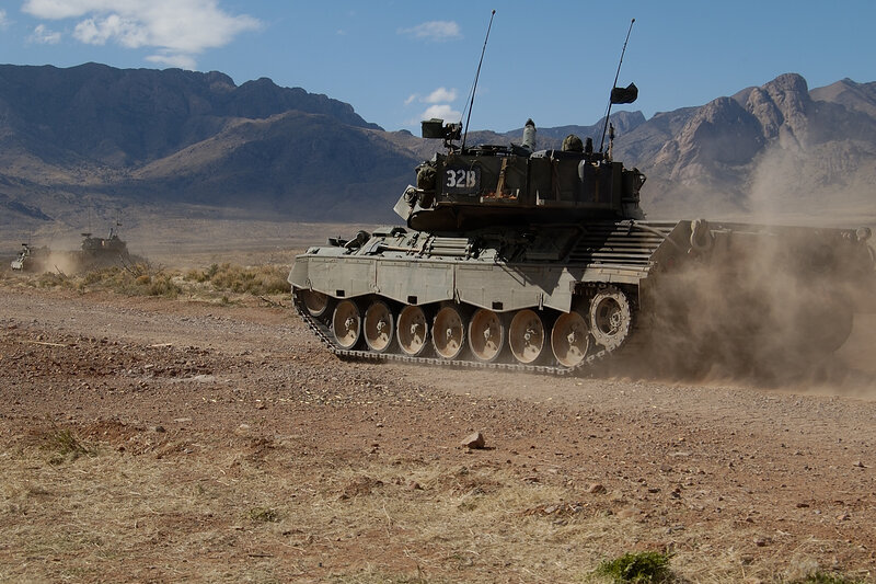 Military tanks in desert terrain