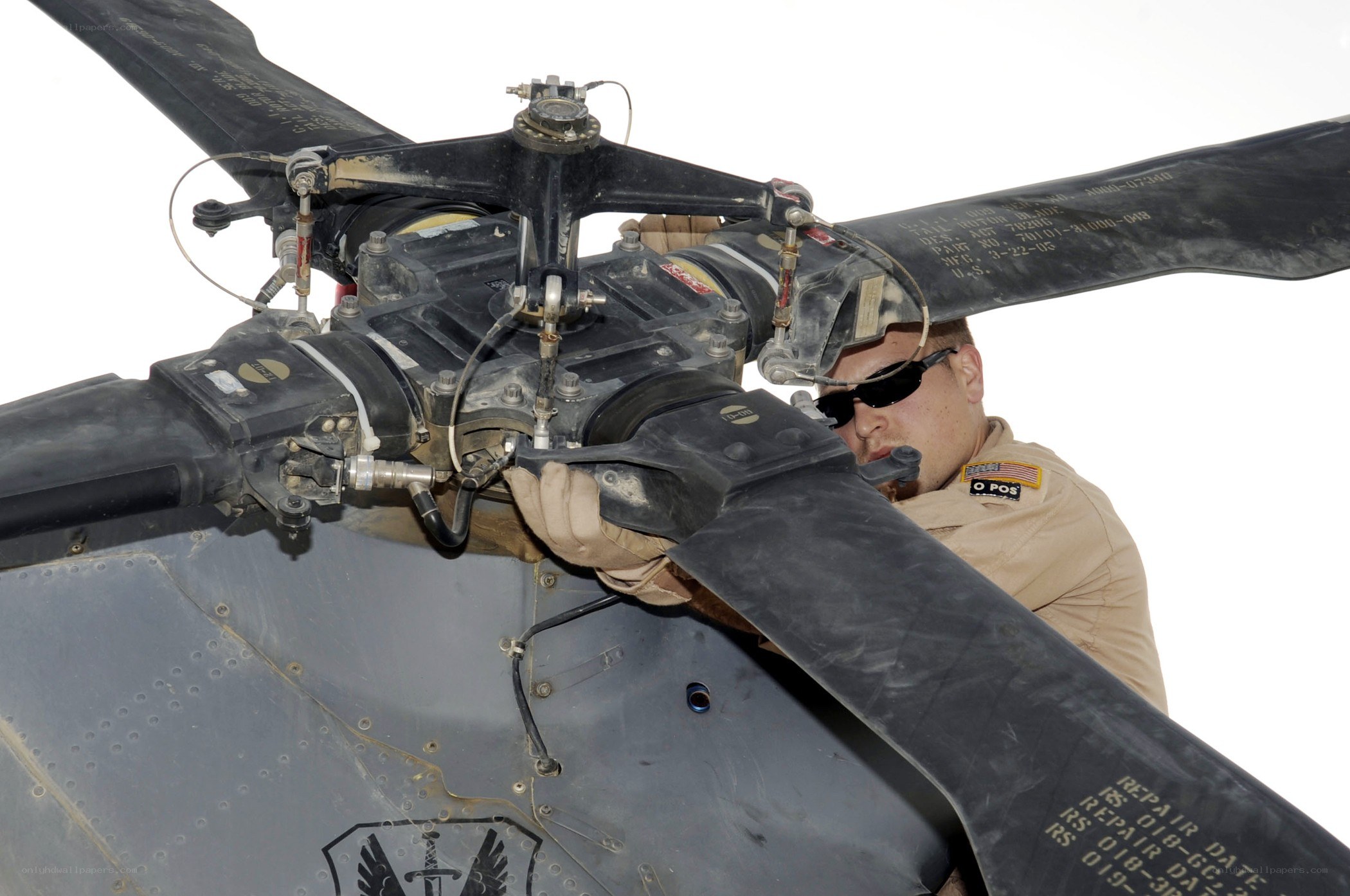 Military technician working on helicopter