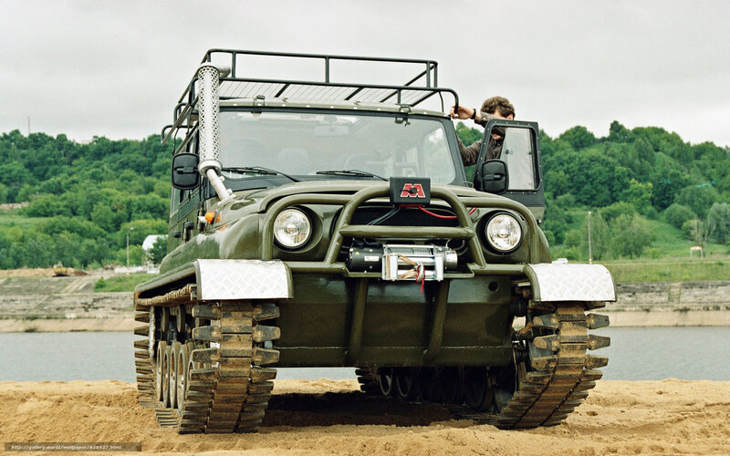 Military tracked vehicle on beach