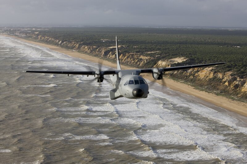 military transport plane over coastline