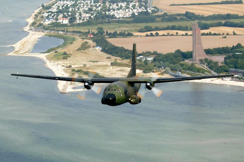 military transport plane over coastline