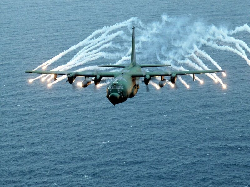 Military transport plane releasing flares