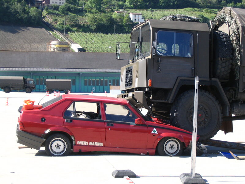 Military truck crushing car