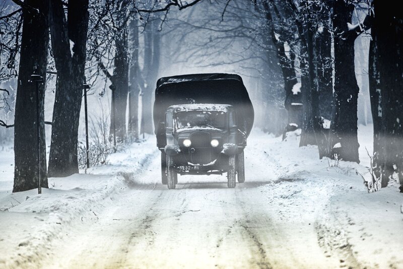 Military truck in snowy forest