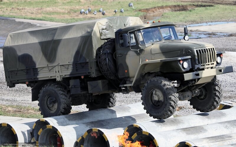 Military truck navigating obstacle course