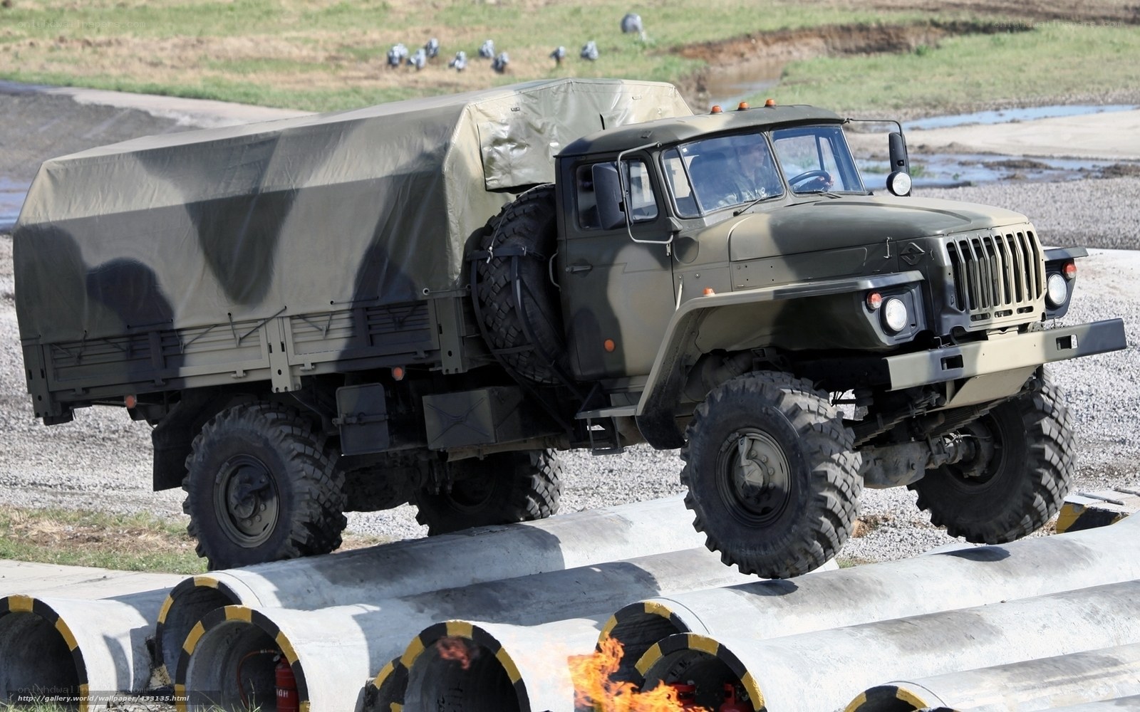 Military truck navigating obstacle course