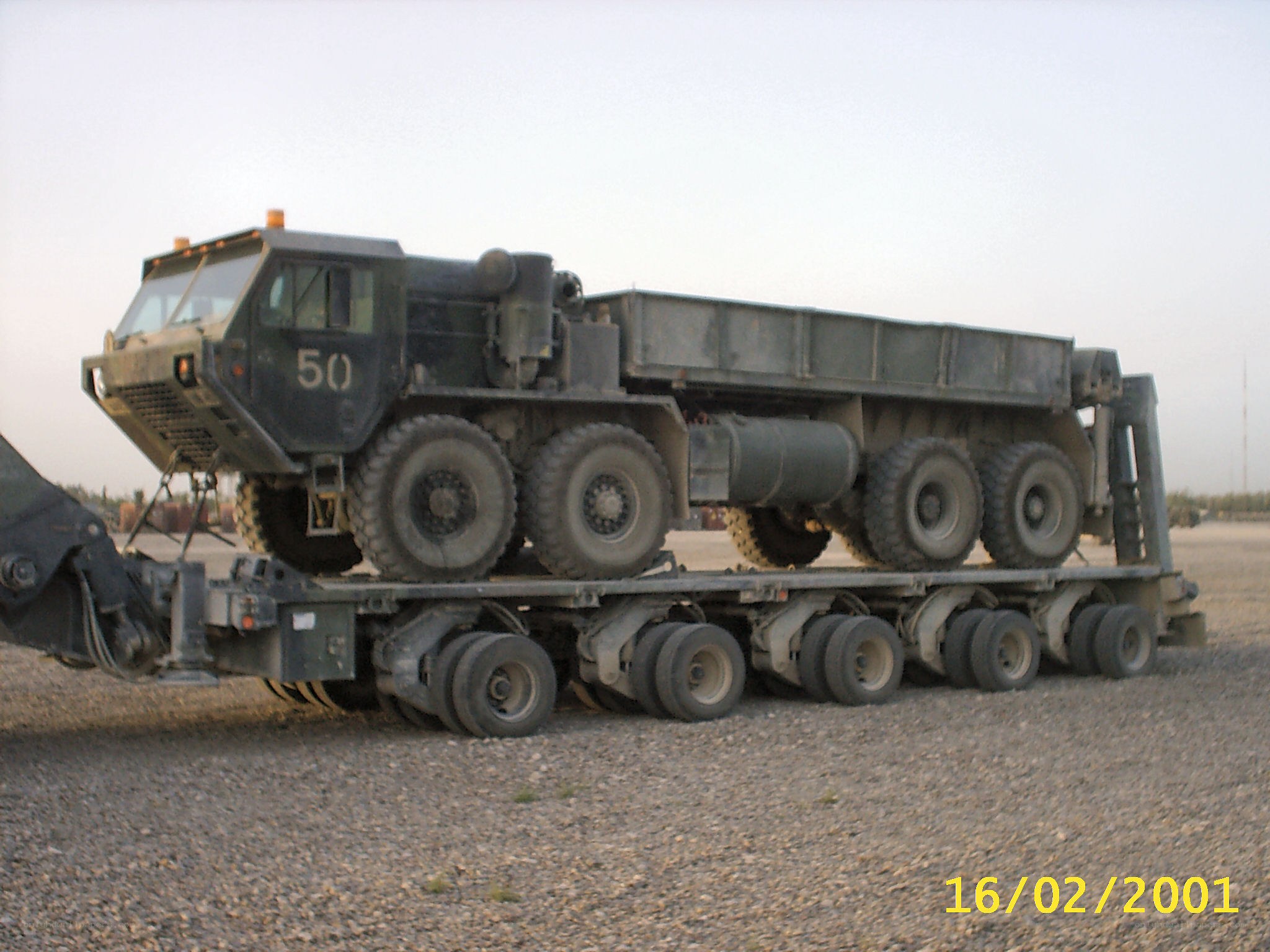 Military truck on flatbed trailer