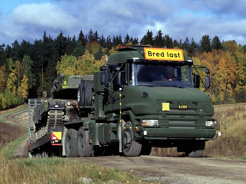 Military truck transporting tank