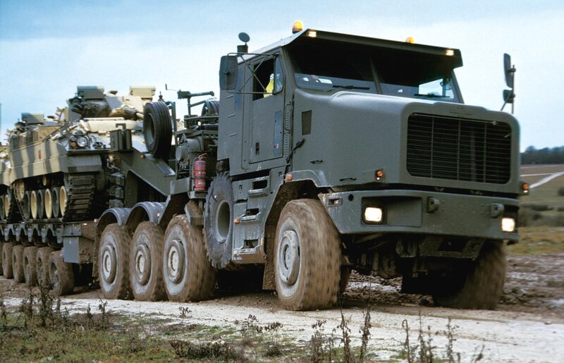Military truck transporting tank