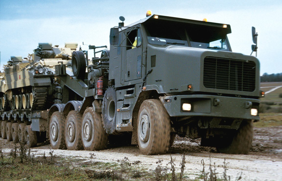 Military truck transporting tank