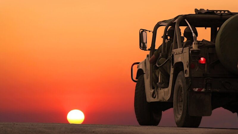 Military vehicle at sunset