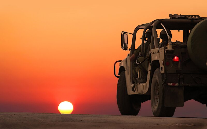 Military vehicle at sunset