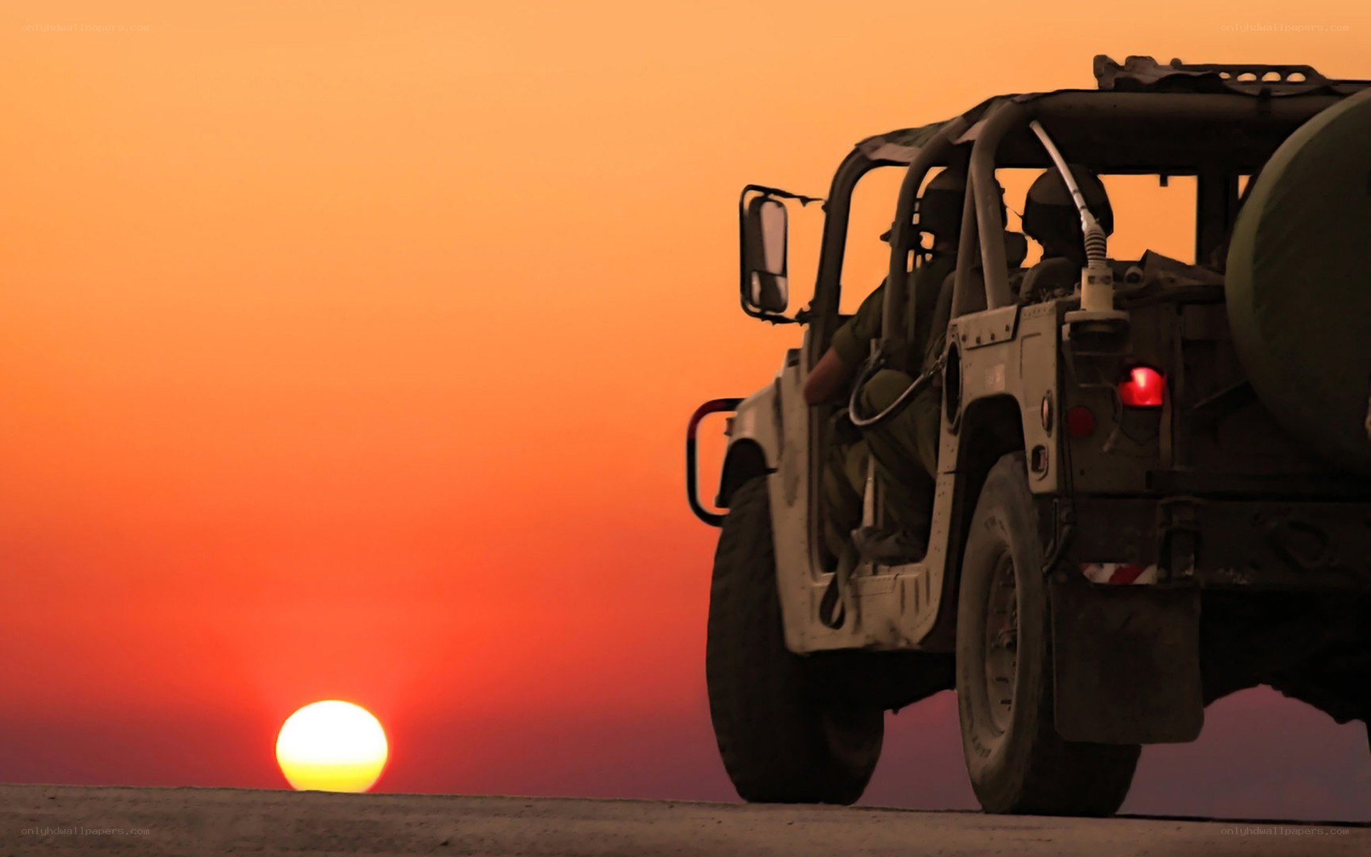 Military vehicle at sunset