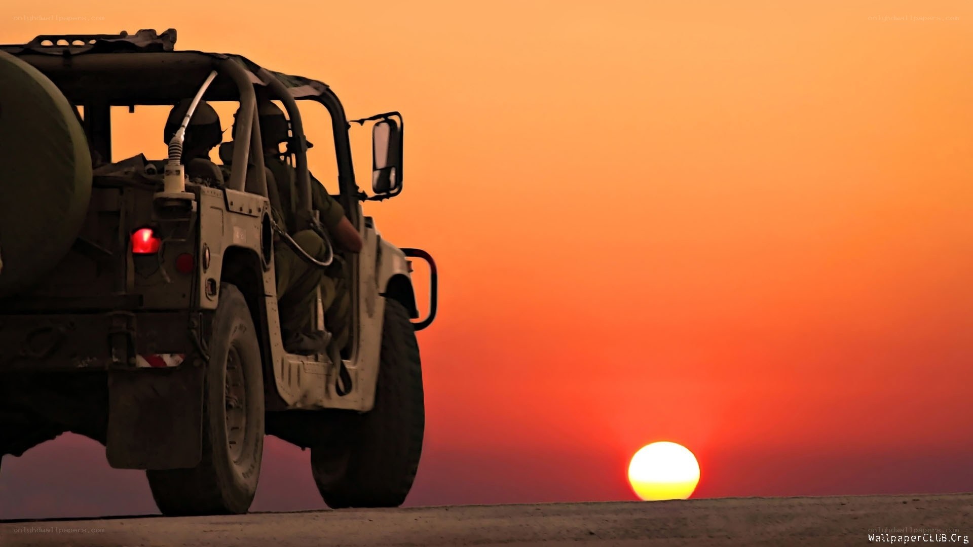 Military vehicle at sunset