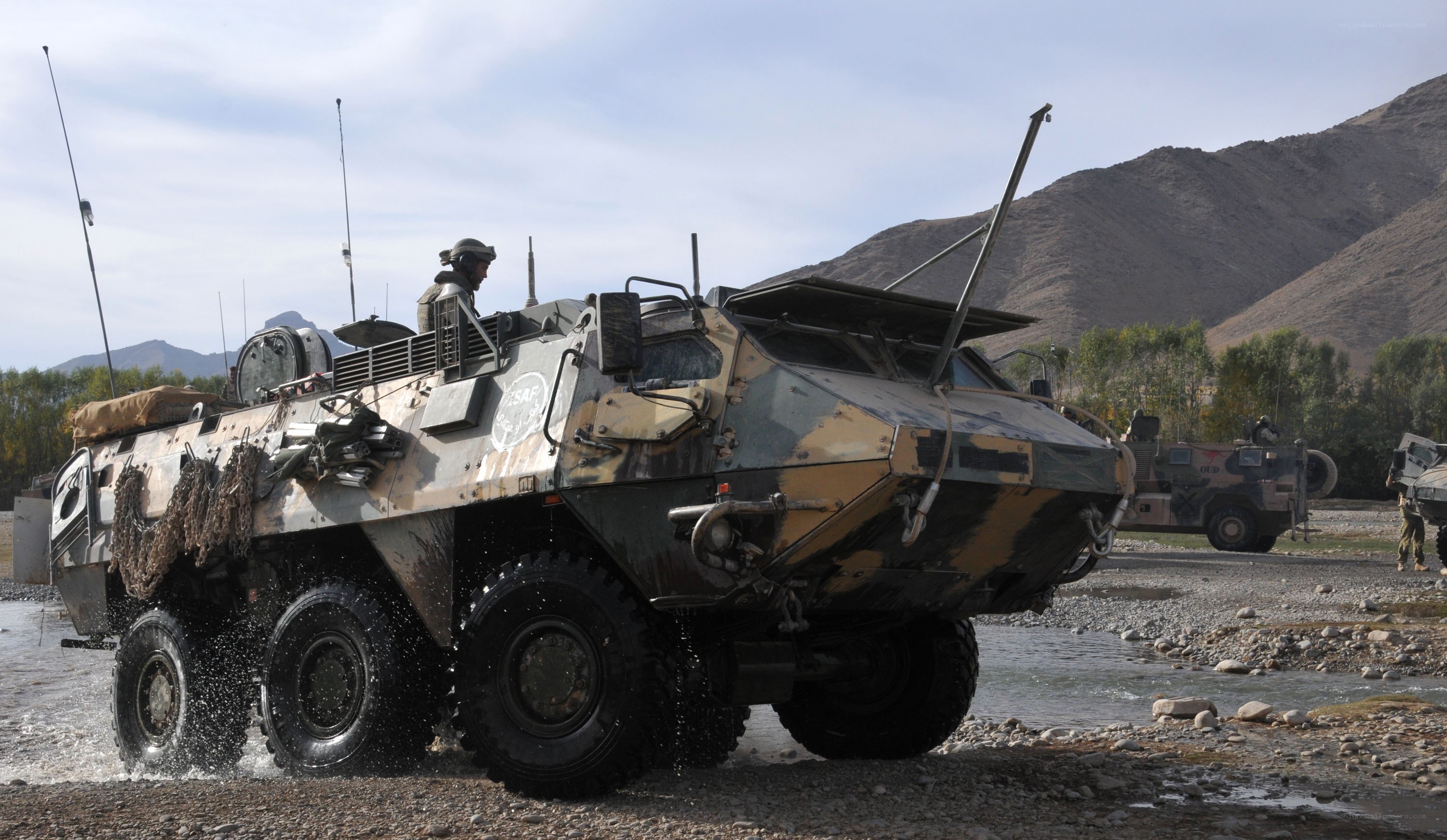 Military vehicle crossing river