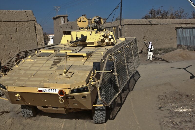 Military vehicle in a village