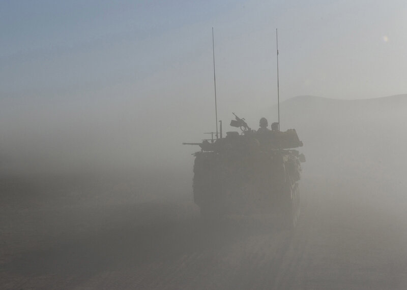 Military vehicle in desert haze